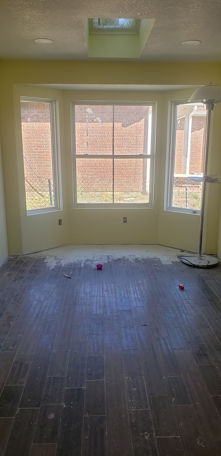 Renovated room with recessed lighting and new flooring